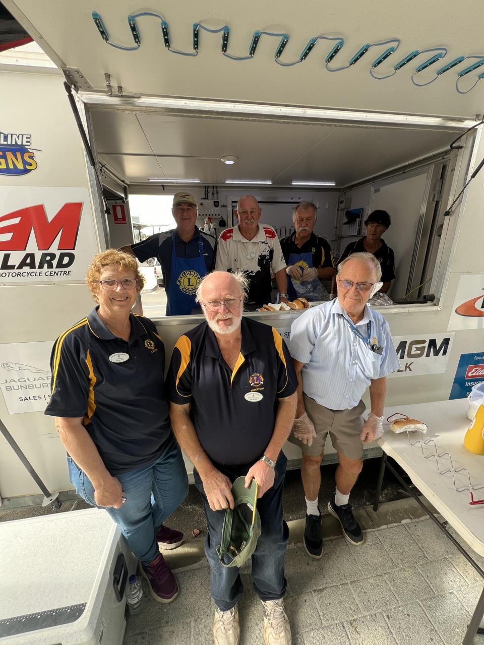 Members of the Eaton Lions Club man the sausage sizzle for the Community Open Day.